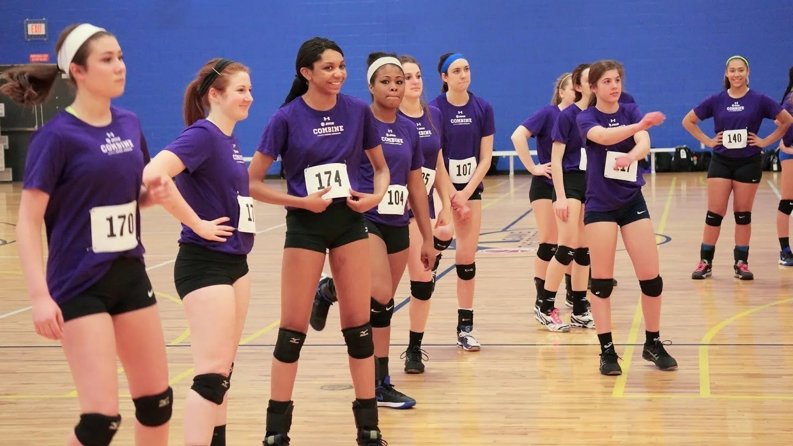 Volleyball players wearing custom sublimated volleyball jerseys