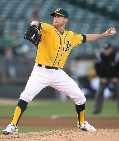 Baseball player wearing rolled-up baseball pants